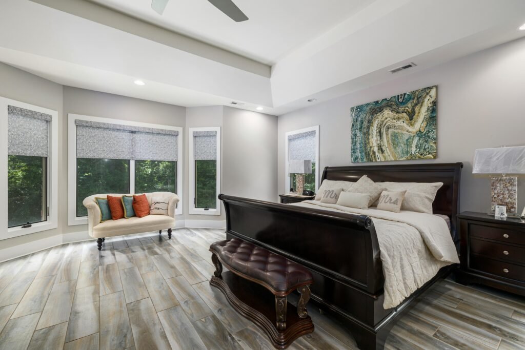 Sophisticated modern bedroom featuring luxurious furniture, large windows, and stylish decor with ample natural light.